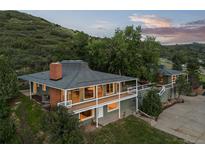 Charming home featuring a spacious deck and picturesque views of the surrounding hillside at 974 N Faver Dr, Castle Rock, CO 80109