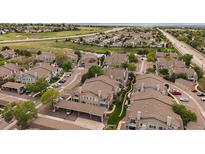 A beautiful aerial view of the condos nestled in a well-kept community with mature trees and landscaping at 3845 Canyon Ranch Rd # 102, Highlands Ranch, CO 80126