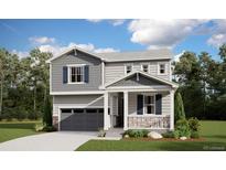 Two-story house with gray siding, a front porch, and a two-car garage at 9165 Truckee Ct, Commerce City, CO 80022