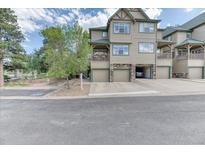 Inviting townhome featuring an attached garage and charming, covered balcony with lovely stone accents at 31112 Black Eagle Dr # 101, Evergreen, CO 80439