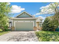 Charming home with a two-car garage, well-manicured lawn, and beautiful landscaping at 19804 E Villanova Pl, Aurora, CO 80013
