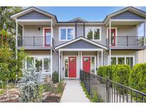 Inviting townhome exterior with red doors, balconies, and a well-maintained front yard at 4728 S Acoma St, Englewood, CO 80110