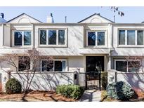 Charming townhome exterior with manicured landscaping, a secure front gate, and large, bright windows at 221 Adams St, Denver, CO 80206