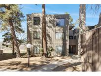 Multi-level condo complex with neutral-colored siding and mature trees surrounding the building at 2525 S Dayton Way # 1514, Denver, CO 80231