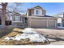 Two-story house with a large yard and attached two-car garage at 5593 S Himalaya Way, Centennial, CO 80015