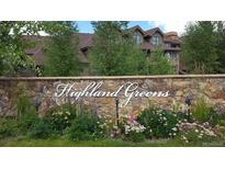 Stone signage for Highland Greens community with greenery and landscaping, surrounded by mature trees and complex at 34 Highfield Trl # 212, Breckenridge, CO 80424