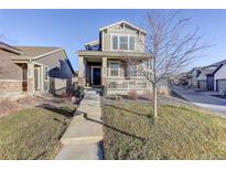 Charming two-story home with inviting porch and well-maintained front yard at 4754 N Joplin St, Denver, CO 80239