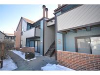 Multi-level condo building with brick accents, outdoor staircase and balcony at 11937 E Harvard Ave # 101, Aurora, CO 80014