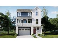 Two-story farmhouse-style home with blue and white exterior, and two-car garage at 6657 E 149Th Dr, Thornton, CO 80602