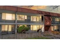 Two-story townhouse showcasing balconies and a privacy fence, offering a blend of indoor-outdoor living and neighborhood charm at 10185 W 25Th Ave # 31, Lakewood, CO 80215