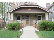 Charming brick home with a beautiful tiled roof and a manicured front yard at 1395 S Josephine St, Denver, CO 80210