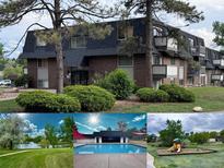 Brick apartment building featuring a lush lawn, mature trees, and community amenities including a pool and playground at 50 E Highline Cir # 101, Centennial, CO 80122