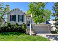 Charming two-story home features a well-manicured lawn, mature trees, and a welcoming entrance at 11182 W 103Rd Cir, Broomfield, CO 80021