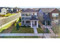 Charming two-story home featuring modern architecture, a well-maintained lawn, and a welcoming front porch at 2754 W 69Th Ave, Denver, CO 80221