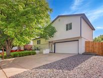 Charming two-story home with a two car garage and landscaped front yard at 1517 S Elkhart St, Aurora, CO 80012
