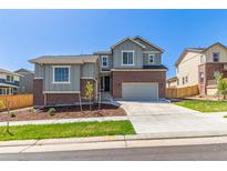 Charming two-story home featuring brick accents, neutral siding, a well-manicured lawn, and a two-car garage at 434 W 128Th Dr, Westminster, CO 80234