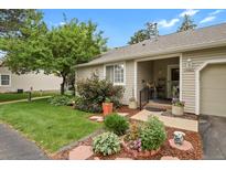 Charming home with beautiful landscaping, a cozy porch, and a well-maintained lawn at 13781 E Marina Dr # A, Aurora, CO 80014