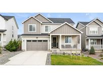Attractive two-story home featuring a two-car garage, well-kept lawn, and modern architectural design at 1101 E Witherspoon Dr, Elizabeth, CO 80107