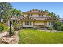 Charming two-story home featuring well-manicured lawn, attractive landscaping, and a unique tiled roof at 4780 W 102Nd Pl, Westminster, CO 80031