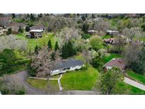 Stunning aerial view of a charming home nestled among lush greenery and mature trees at 1930 Taft Dr, Lakewood, CO 80215