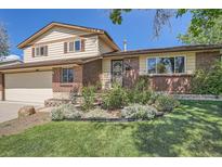 Charming two-story home with brick and siding exterior and a well-manicured front yard at 9270 Tennyson St, Westminster, CO 80031