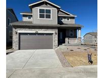Charming two-story home with stone accents, a two-car garage, and a welcoming front porch at 739 N Deer Park St, Watkins, CO 80137