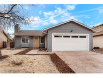 Charming home with an attached two-car garage, neutral gray paint, and beautifully landscaped front yard at 3643 S Mobile Way, Aurora, CO 80013