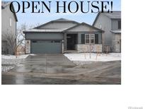 Inviting single-story home featuring a gray exterior, a two-car garage, and manicured landscaping at 1947 S Coolidge Way, Aurora, CO 80018