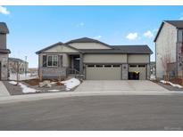 Charming single-Gathering home with a three-car garage, stone accents, and a well-maintained lawn on a sunny day at 1947 S Coolidge Way, Aurora, CO 80018