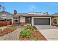 Charming single-Gathering home with a well-manicured front yard, solar panels, and an attached garage at 12164 E Amherst Cir, Aurora, CO 80014