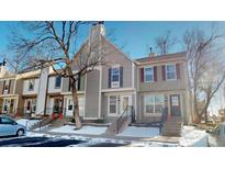 Attractive townhome exterior with snow-covered landscaping at 1811 S Quebec Way # 194, Denver, CO 80231