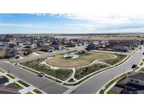 A beautiful aerial view of a Primary-planned community featuring a central park and walking trails at 17947 E 95Th Ave, Commerce City, CO 80022