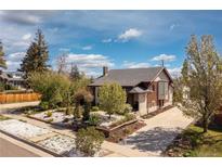 Charming home with a well-manicured lawn, mature trees and a long driveway at 3176 Depew St, Wheat Ridge, CO 80214