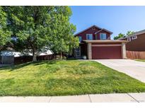 Charming two-story home features a well-manicured lawn, mature shade tree, and attached two-car garage at 5630 W 115Th Ave, Westminster, CO 80020