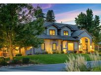Charming two-story home with a well-manicured lawn and mature trees, creating a picturesque setting at 4181 S Ivy Ln, Cherry Hills Village, CO 80111