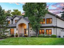 Charming two-story home with landscaped yard and brick accents, set beneath a beautiful evening sky at 4181 S Ivy Ln, Cherry Hills Village, CO 80111