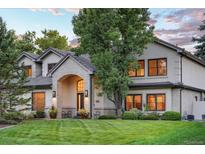 Charming home with a well-manicured lawn, mature tree, and a welcoming brick entryway at 4181 S Ivy Ln, Cherry Hills Village, CO 80111