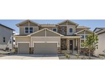 Charming two-story home featuring a two-car garage and stone accents on the facade, nestled in a well-maintained community at 4769 Weitbrec Ln, Castle Rock, CO 80104