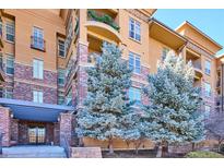 Attractive condo building with brick and stucco exterior and nicely landscaped entrance at 7865 Vallagio Ln # 207, Englewood, CO 80112