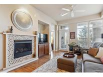 Inviting living room featuring a tiled fireplace, ceiling fan, and neutral tones at 7865 Vallagio Ln # 207, Englewood, CO 80112