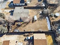 An aerial view of a property with a large yard and neighboring houses at 8280 E 104Th Way, Henderson, CO 80640