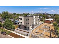 Aerial view of modern home with landscaping and city skyline in the background at 1372 Lowell Blvd # 1, Denver, CO 80204