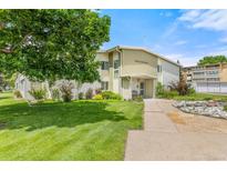 Well-maintained condo building with manicured lawn and mature trees in a desirable community at 9320 E Center Ave # 4B, Denver, CO 80247