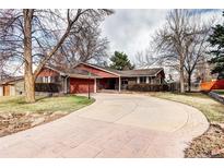 Spacious brick home with an attached garage and beautiful landscaping at 3820 S Ames St, Denver, CO 80235