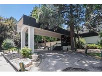 Welcoming entrance to the building with a covered drive-through and meticulously landscaped grounds at 2375 S Linden Ct # 201, Denver, CO 80222