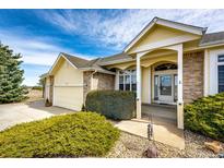 Charming single-Gathering home featuring a welcoming front porch and an attached two-car garage at 34942 Wagon Wheel Trl, Elizabeth, CO 80107