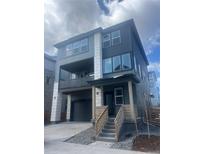 Modern two-story home with a covered porch, neutral paint scheme, and stone accents at 8859 Waterleaf Ln, Littleton, CO 80125