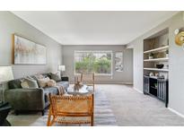 Cozy living room with large windows and built-in shelving offers comfortable and stylish seating at 9283 E Arbor Cir # C, Englewood, CO 80111