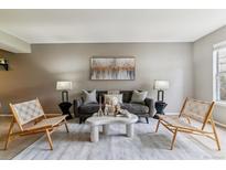 Cozy living room featuring a modern sofa, decorative coffee table, and stylish accent chairs at 9283 E Arbor Cir # C, Englewood, CO 80111