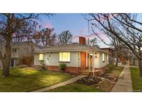 Charming single-Gathering home with brick accents, well-maintained lawn, and inviting curb appeal at dusk at 1295 Elm St, Denver, CO 80220